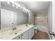 Bathroom with a double vanity, tiled floor and shower with grab bars at 4703 Paces Ferry Dr, Durham, NC 27712