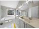Bathroom features a double vanity, a large soaking tub and a window at 4703 Paces Ferry Dr, Durham, NC 27712