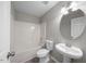 Clean and bright bathroom with shower-tub combo, toilet, and a pedestal sink at 4703 Paces Ferry Dr, Durham, NC 27712