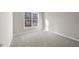Spacious bedroom with neutral walls, carpet, and a large window offering a view at 4703 Paces Ferry Dr, Durham, NC 27712