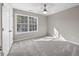 Well-lit bedroom features neutral walls, soft carpet, and a large window with natural light at 4703 Paces Ferry Dr, Durham, NC 27712