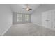 Spacious carpeted bedroom with two windows and a closet at 4703 Paces Ferry Dr, Durham, NC 27712