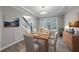 Bright dining room with wood table set for six, chandelier, and modern decor at 4703 Paces Ferry Dr, Durham, NC 27712