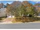 Charming home with a two-car garage and a welcoming front porch, surrounded by mature trees at 4703 Paces Ferry Dr, Durham, NC 27712