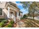 Charming brick home featuring a welcoming front porch with white columns and steps at 4703 Paces Ferry Dr, Durham, NC 27712