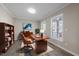 Inviting home office with wood desk, neutral walls, natural light and an attractive area rug at 4703 Paces Ferry Dr, Durham, NC 27712