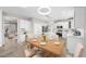 Bright eat-in kitchen features white cabinets, stainless appliances, and modern lighting at 4703 Paces Ferry Dr, Durham, NC 27712
