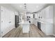 Bright kitchen featuring stainless appliances, a large island, and white cabinets at 4703 Paces Ferry Dr, Durham, NC 27712
