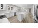 Modern kitchen with marble countertops, stainless appliances, and white cabinets at 4703 Paces Ferry Dr, Durham, NC 27712