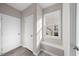 Mud room entrance featuring vinyl flooring, bench seating, and a sunlit window at 4703 Paces Ferry Dr, Durham, NC 27712