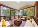 Screened porch with comfortable wicker furniture and wooded views at 4703 Paces Ferry Dr, Durham, NC 27712