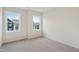 A carpeted bedroom with two windows that allow an abundance of natural light at 4804 Cypress Tree Ln, Raleigh, NC 27612
