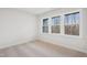 A bedroom with a carpeted floor and a large window for natural light at 4804 Cypress Tree Ln, Raleigh, NC 27612