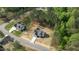 An aerial view of a home nestled in a wooded area, highlighting its landscaping and nearby houses at 50 Arbor Dr, Youngsville, NC 27596
