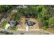 An aerial view of a home nestled in a wooded area, showcasing its location and surrounding trees at 50 Arbor Dr, Youngsville, NC 27596