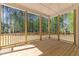 Spacious back porch with wooden beams and railing overlooks trees and greenery at 50 Arbor Dr, Youngsville, NC 27596
