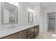 Modern bathroom featuring double sinks, quartz counters, and a large walk-in closet at 50 Arbor Dr, Youngsville, NC 27596