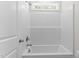 Bathroom tub/shower combo with white tile and chrome fixtures at 50 Arbor Dr, Youngsville, NC 27596