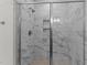This marble shower features a sliding door enclosure and built-in shelf at 50 Arbor Dr, Youngsville, NC 27596