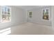 Cozy bedroom with neutral carpet and bright natural light from three windows at 50 Arbor Dr, Youngsville, NC 27596