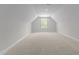 Large bonus room features neutral carpet, white walls and a window for natural light at 50 Arbor Dr, Youngsville, NC 27596