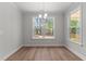 Bright dining area with large windows, hardwood floors, and modern light fixture at 50 Arbor Dr, Youngsville, NC 27596