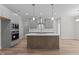 Modern kitchen featuring stainless steel appliances, large island, and sleek cabinetry at 50 Arbor Dr, Youngsville, NC 27596