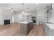 Modern kitchen featuring stainless steel appliances, large island, and open layout to the living area at 50 Arbor Dr, Youngsville, NC 27596
