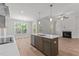 Modern kitchen featuring an island with bar seating, stainless steel appliances, and an open floor plan at 50 Arbor Dr, Youngsville, NC 27596