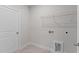 The spacious laundry room has tile flooring and storage with washer and dryer hookups at 50 Arbor Dr, Youngsville, NC 27596
