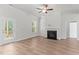 Cozy living room featuring a fireplace, ceiling fan, and access to an outdoor deck at 50 Arbor Dr, Youngsville, NC 27596