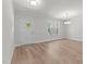 Bright living area with hardwood floors, large window, and a contemporary light fixture at 50 Arbor Dr, Youngsville, NC 27596