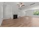 Bright living room with a fireplace, ceiling fan and wood-look floors at 50 Arbor Dr, Youngsville, NC 27596