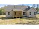 Exterior shot of a home's backyard, complete with a wooden porch and neutral siding at 50 Arbor Dr, Youngsville, NC 27596