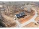 Aerial view of single-story home on wooded lot with a gravel driveway at 5724 Walters Ln, Burlington, NC 27217