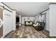 Spacious living room with wood-look floors, barn doors, and leather furniture at 5724 Walters Ln, Burlington, NC 27217