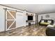 Living area with wood-like floors and barn doors at 5724 Walters Ln, Burlington, NC 27217