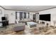 Spacious living room with gray sofas and a large TV at 5724 Walters Ln, Burlington, NC 27217
