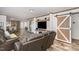 Open concept living room with wood-look floors and barn doors at 5724 Walters Ln, Burlington, NC 27217