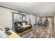Living room with open floor plan, leather furniture, and wood-look floors at 5724 Walters Ln, Burlington, NC 27217