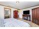 Main bedroom with fireplace, TV, and large windows at 5724 Walters Ln, Burlington, NC 27217