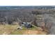 Stunning aerial view of sprawling property with mature trees, fenced-in yard, garden and charming home at 7700 Circle L Trl, Rougemont, NC 27572