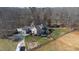 Beautiful aerial view of the house and property showcasing the landscaping and various buildings at 7700 Circle L Trl, Rougemont, NC 27572