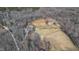 Expansive aerial view of a multi-building farm estate with fenced pastureland and surrounding woods at 7700 Circle L Trl, Rougemont, NC 27572