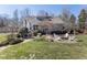 Landscaped backyard with a screened porch, fire pit, and Adirondack chairs offering a relaxing outdoor space at 7700 Circle L Trl, Rougemont, NC 27572