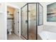 Bathroom featuring tile shower, soaking tub, and views to built-in shelving at 7700 Circle L Trl, Rougemont, NC 27572