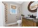 Bathroom with granite countertop vanity, decorative mirror, and tiled shower at 7700 Circle L Trl, Rougemont, NC 27572