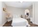 Bright bedroom featuring neutral tones, hardwood floors, and a connecting doorway at 7700 Circle L Trl, Rougemont, NC 27572
