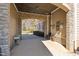 Covered breezeway offering access to the home with stone accents and outdoor charm at 7700 Circle L Trl, Rougemont, NC 27572