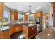 Well-lit kitchen with a center island, stainless steel appliances, and wooden cabinets with stone countertops at 7700 Circle L Trl, Rougemont, NC 27572